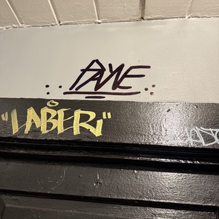 Urban Street Art and Graffiti Tags on Building Wall