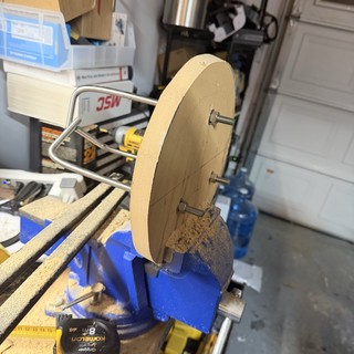 Wooden Wheel Secured in Blue Workshop Vise