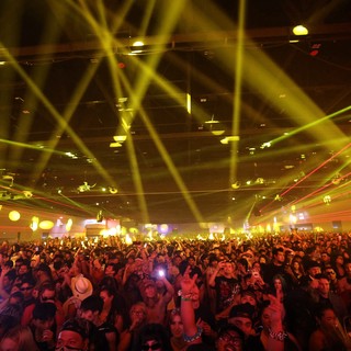 Massive Indoor Crowd Bathed in Laser Light Show