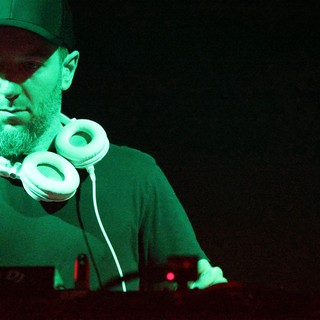 DJ Lost in the Mix Under Green Stage Light