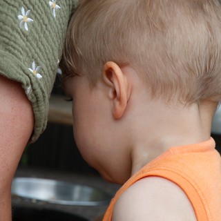 Tender Moment: Child Nestled Against Parent's Shoulder