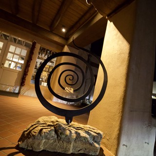 Spiral Sculpture in Warm-Lit Adobe Interior
