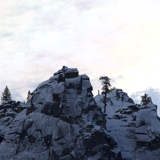 Rocky Summit with Snow-Dusted Evergreens at Dusk