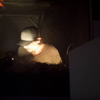 Hat-wearing DJ in the Dark