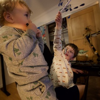 Two Children Playing at Gaming Setup in Pajamas