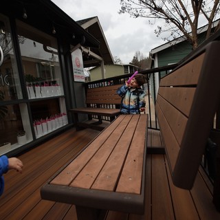 Child on Outdoor Restaurant Deck on Cloudy Day