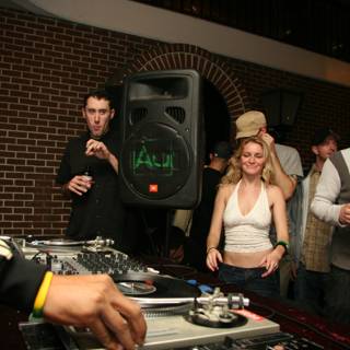 DJ in Black Jacket Spins Music at Nightclub