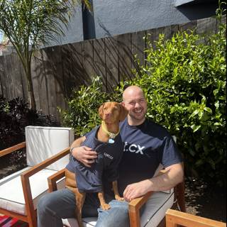 Man and Dog on the Backyard Chair