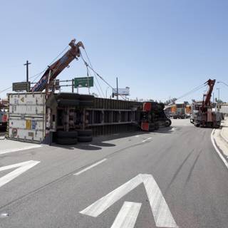 Overturned Truck Lifted by Construction Crane on Street