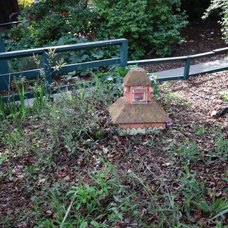 Whimsical Thatched Fairy House in Garden Setting