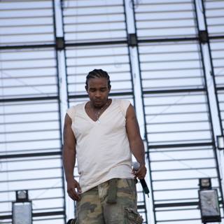 Pharoahe Monch Rocks the Stage in Camouflage and White Tank Top