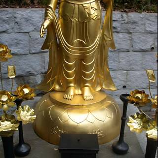 Golden Buddha Statue with Gold Flowers and Candles in Kyoto Temple