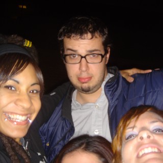 Friends Posing Together at a Nighttime Outdoor Event