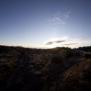 Sunset Over Desert Landscape with Train Car