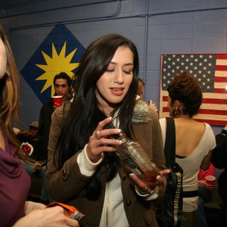 Two Women at an Indoor Party with Flags