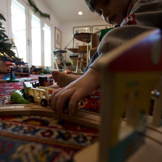 Child Playing with Toy Trains on Christmas Morning
