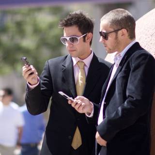 Businessmen checking their phones