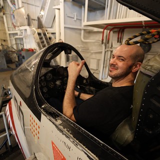 Aircraft Mechanic Restoring Vintage Military Fighter Cockpit