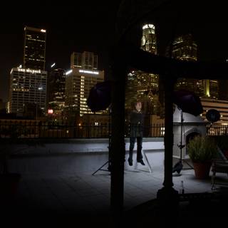 Urban Night Skyline with Chair and Decorative Plant
