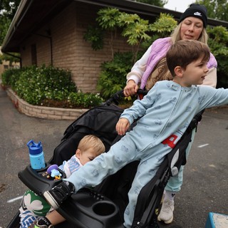 Mom Pushes Two Kids in Stroller at Balloon Festival