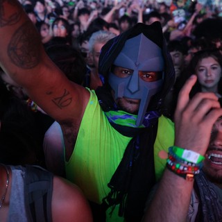 Masked Festival Reveler Stands Out in Crowd