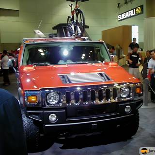 Red Hummer Truck with Bicycle on Top