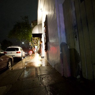Wet Urban Sidewalk on a Misty Night