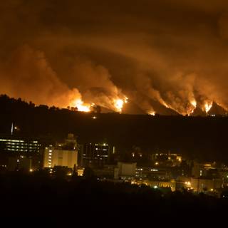 Flames Engulfing the Hills Above the City