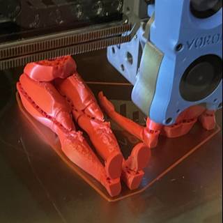 3D Printed Robot with a Red Arm
