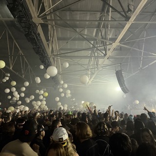 Skrillex Concert with Floating Balloons and Massive Crowd