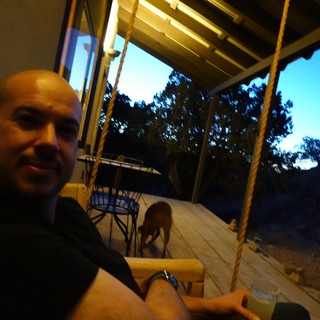 Bald Man Enjoying Evening on Covered Porch