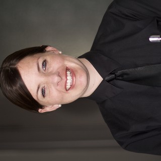 Smiling Service Professional in Black Uniform Portrait