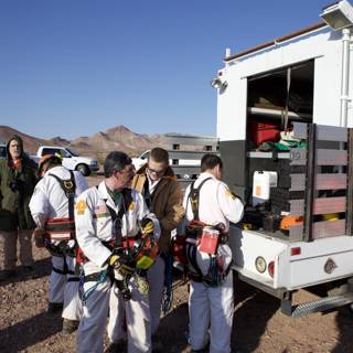 Mine Rescue Team Gathers Around White Truck