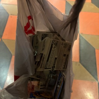 Plastic Shopping Bag with Toy Cars on Colorful Floor