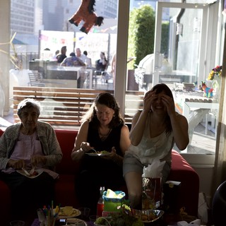 Three Generations Share Laughter at Fiesta Party