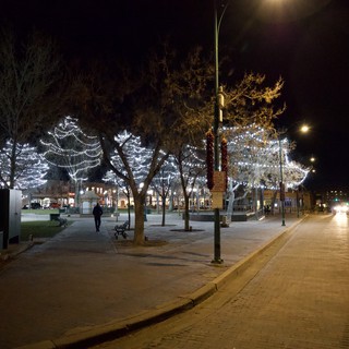 Festive Holiday Lights Illuminate Empty Town Square at Night