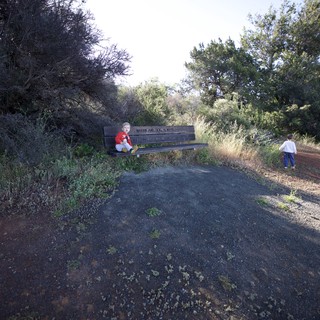 Two Young Children Exploring a Memorial Bench Trail
