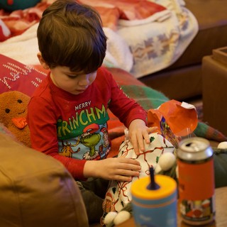 Christmas Morning Joy: Child Opening Holiday Gifts