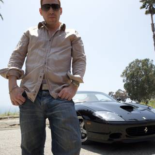 Man posing next to shiny sports car