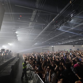 Massive Indoor EDM Crowd Bathed in Stage Light