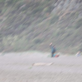 Solitary Camper on Remote Rocky Beach Shore