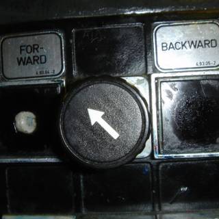 Arrow Button for Electronics Caption: A black button with a right-pointing arrow, tagged for electronics and computer hardware.