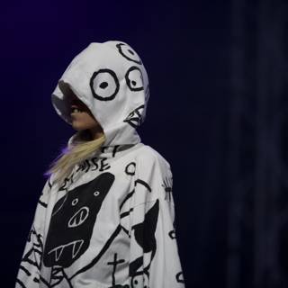 Hooded and Painted Performer Struts Down Coachella Runway