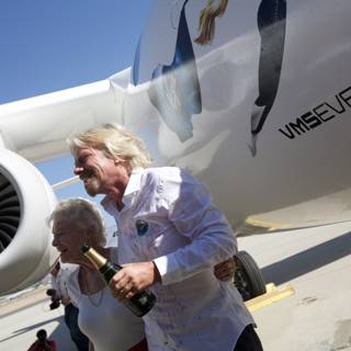 Richard Branson and companions pose next to their aircraft