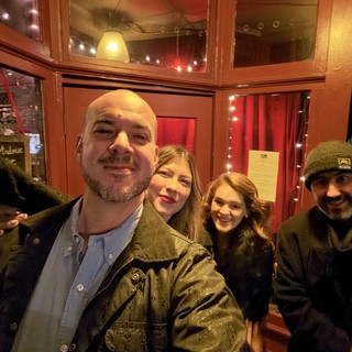 Group Selfie at Cozy Restaurant Entrance