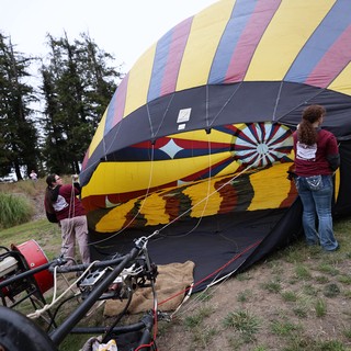 Ground Crew Inflating Colorful Hot Air Balloon at Festival