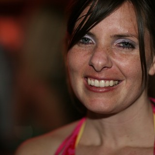 Radiant Smile at a Lively Evening Event