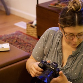 Photographer Reviewing Camera at Home Studio Session
