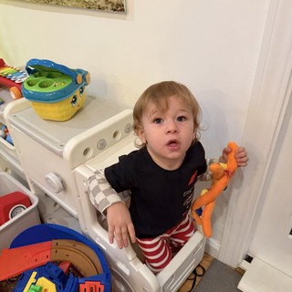 Toddler Playing with Toys in Learning Tower