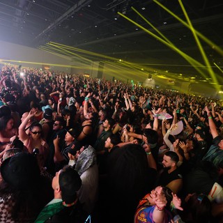 Massive Indoor EDM Festival Crowd Under Laser Light Show